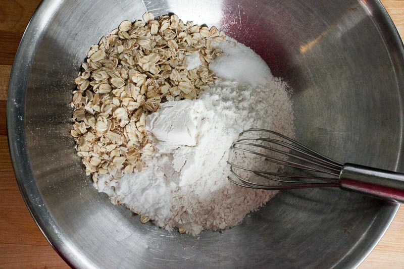 Whisking Together Oats, Flour, Baking Powder and Salt in Metal Mixing Bowl.