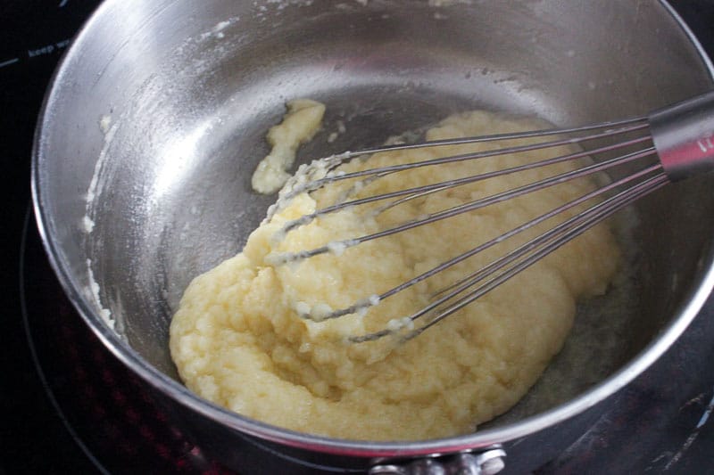 Mixing Roux Mixture in Pot with Whisk.