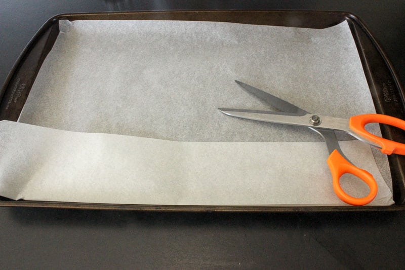 Scissors on Parchment Paper on Sheet Pan.