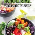 Two black bowls, filled with cubes of sweet potato, sliced red pepper, black beans, diced red onion, sliced avocado, kernels of corn and pieces of red cabbage, with white sauce drizzled over it, set on a table with a white sauce in a jar, some lime wedges, loose cilantro and a purple cloth. Text overlay says Mexican Buddha Bowl with Cilantro Lime Sauce.