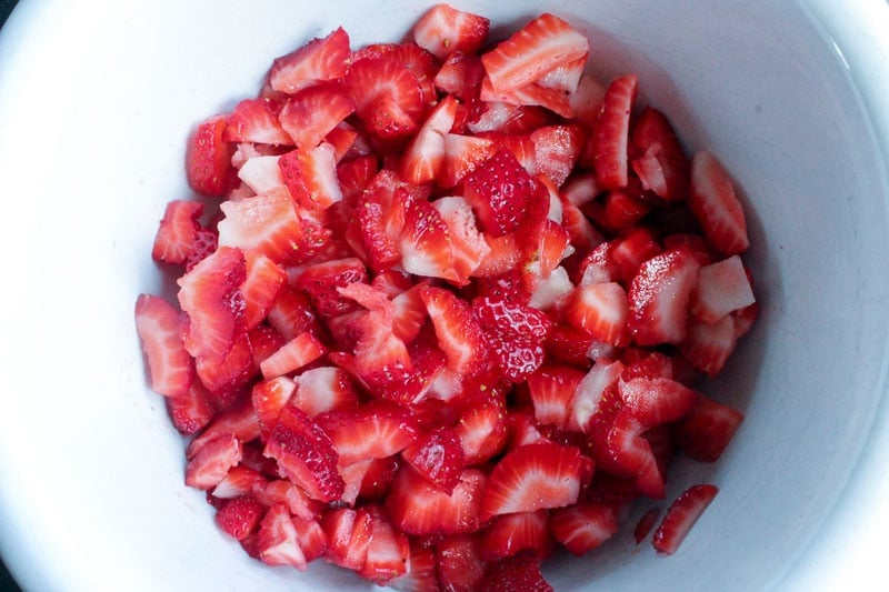 Chopped Strawberries in White Bowl.