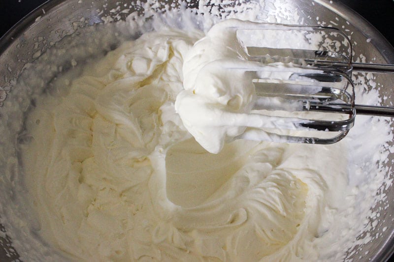 Whipping Cream in Metal Mixing Bowl.