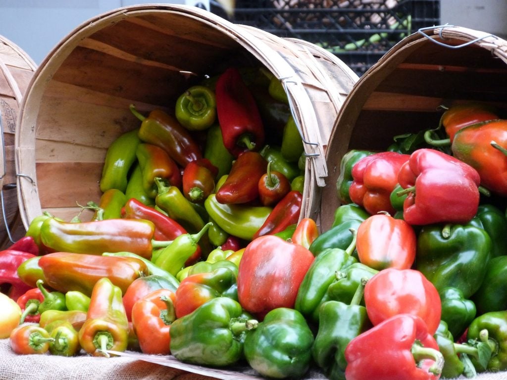 Wooden Baskets Filled with Red and Green Peppers.