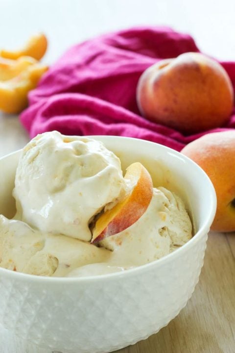 Peach ice cream in a white bowl