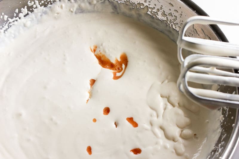 Adding Peach Puree to Whipped Cream and Sweetened Condensed Milk.