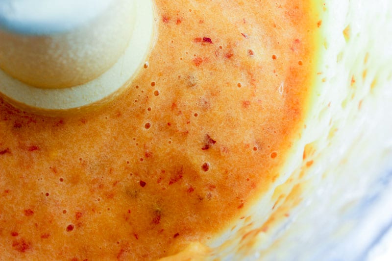 Peach puree in the bowl of a food processor.