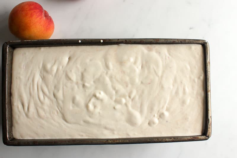 Peach ice cream in a loaf pan.