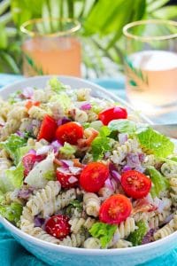 Serving bowl full of bacon, lettuce, tomato pasta salad with creamy sauce