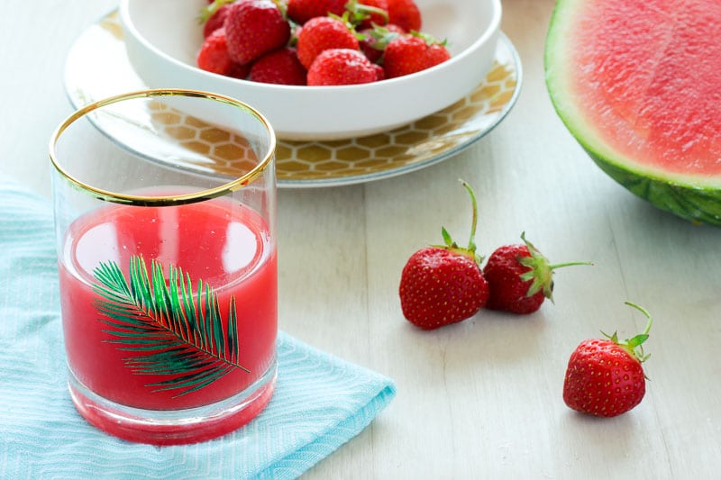 Strawberry Watermelon Juice in Glass on blue cloth.