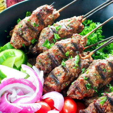 Platter of beef kebabs, cucumber, red onions and grape tomatoes