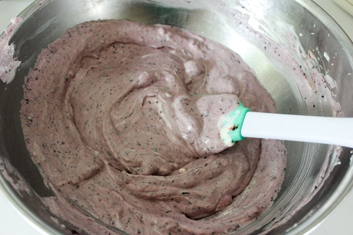 Fold whipped cream into blueberry cheesecake filling