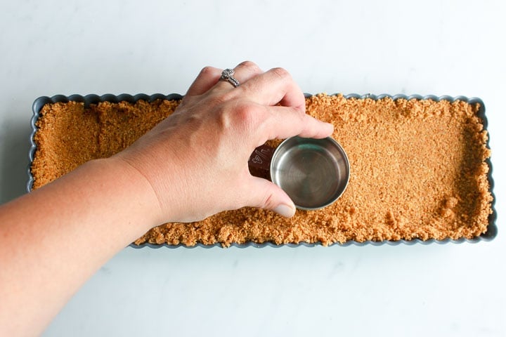 Pressing graham crust into tart pan