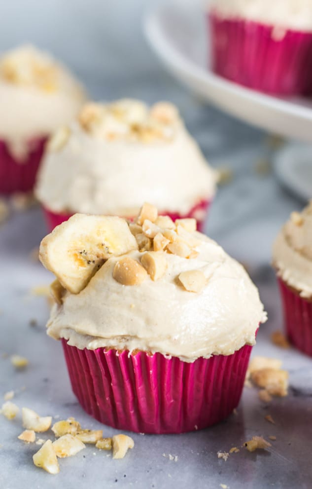 Banana cupcake with peanut butter frosting in a red wrapper