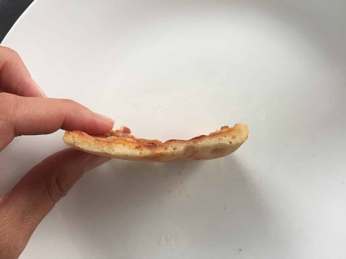 Piece of thin crust pizza
