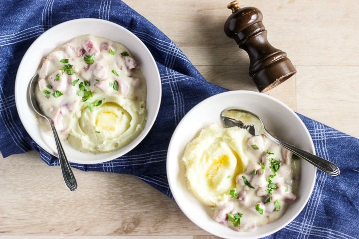 Two bowls of creamed ham in white bowls.