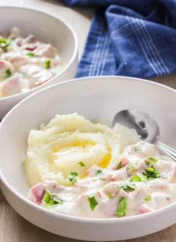 Bowl of leftover ham in basic white sauce with potatoes