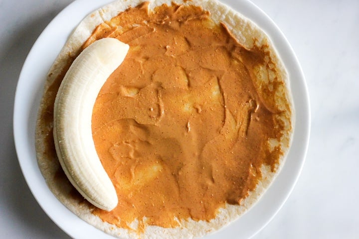 https://deliciousonadime.com/wp-content/uploads/2020/01/Wrap-banana-in-peanut-butter-tortilla-for-a-healthy-protein-box-lunch.jpg