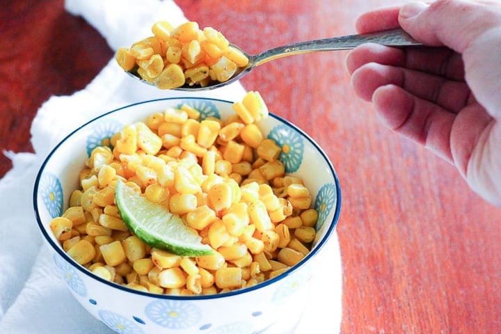 Bowl of corn with wedge of lime