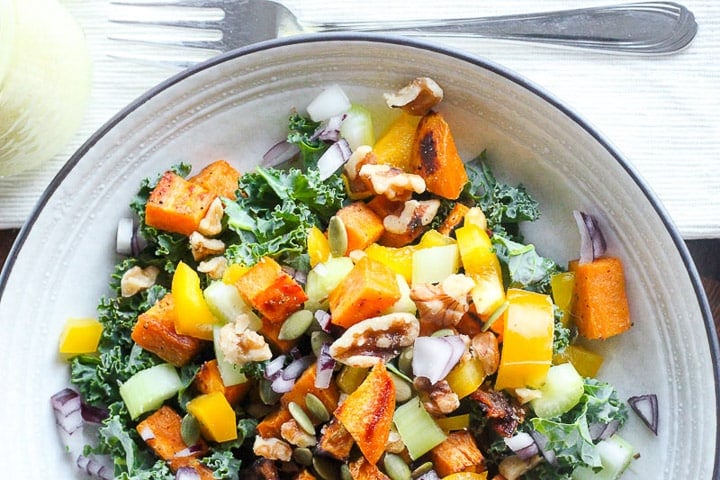 Salad made with kale, sweet potato, celery onion and peppers