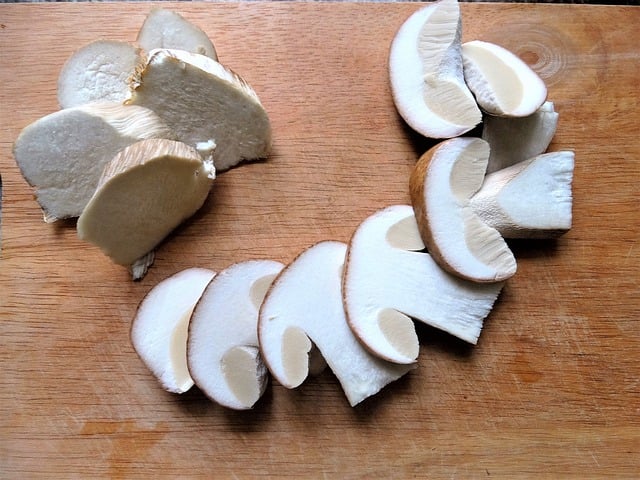 A sliced mushroom on a cutting board