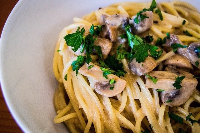 pasta topped with mushrooms and parsley
