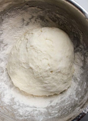 Bowl holding pizza dough that is ready to use