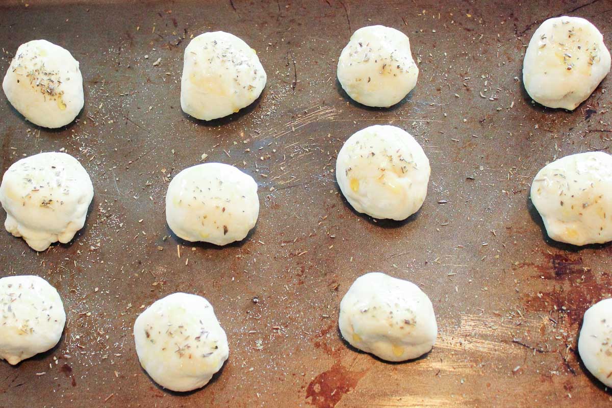 Uncooked pizza pops on pan