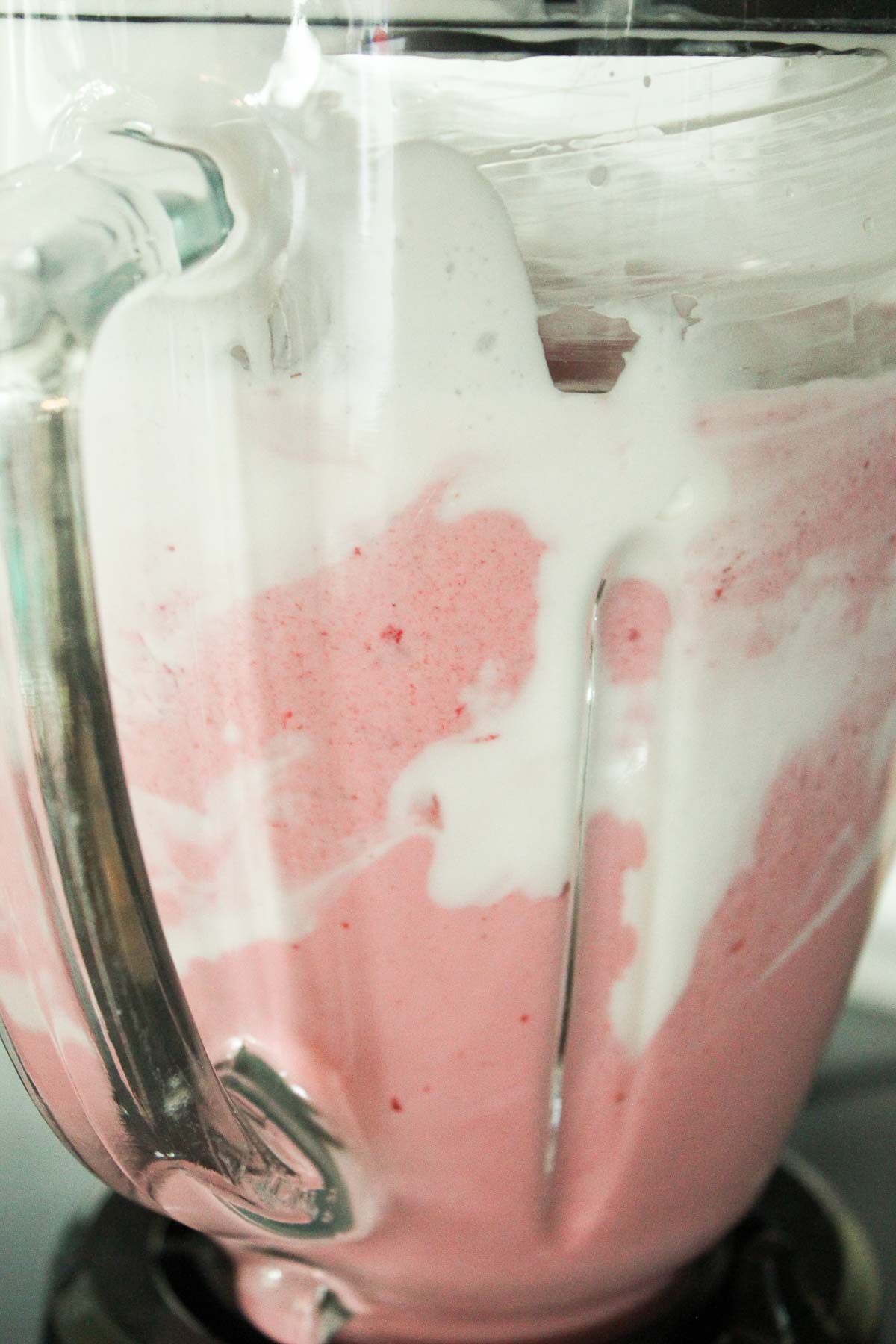 Pink and white healthy protein smoothie in blender