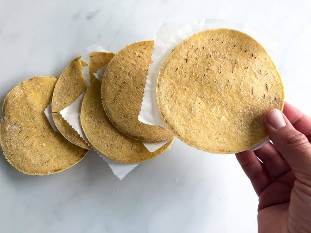 Corn tortillas after defrosting when layered with parchment paper