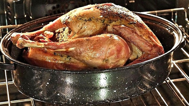 Roasted turkey in pan in oven.