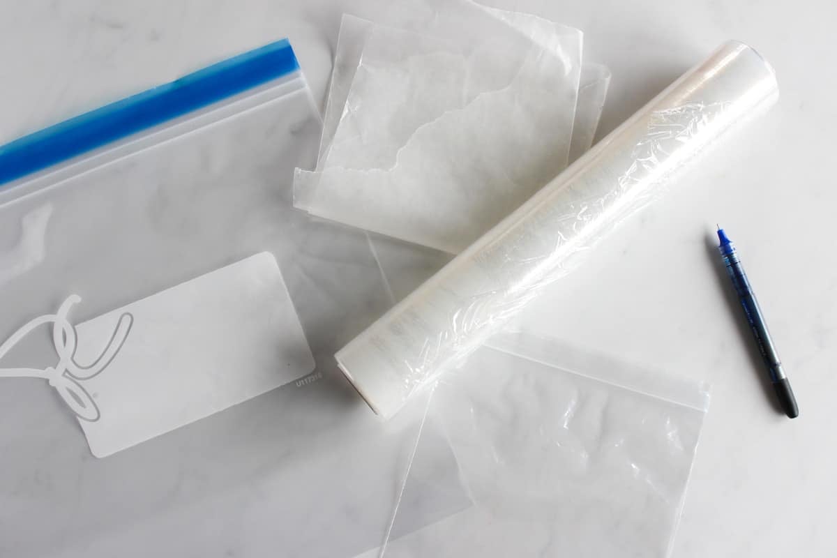 Freezing supplies, including Ziplock freezer bags, baggies, saran wrap, wax paper and pen.